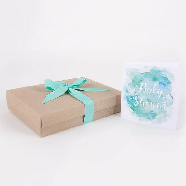 Cardboard gift box with mint colour ribbon and baby shower card