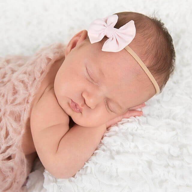 Pink baby headbands on newborn baby