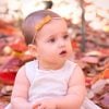 Newborn bows on a baby girl sitting in leaves
