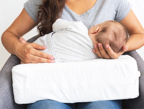 nursing pillow with baby while feeding