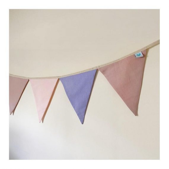 Pink, purple, and dusty pink nursery bunting hanging up
