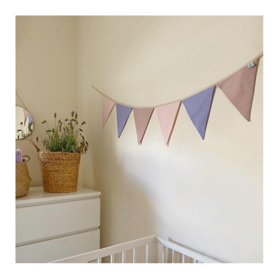 Pink, purple, and dusty pink nursery bunting in room
