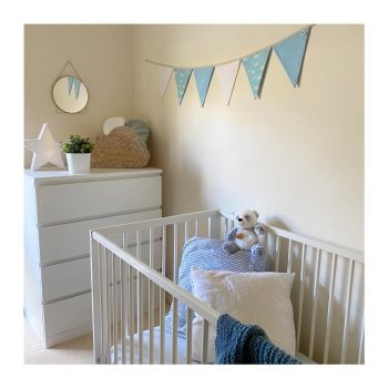 White, clouds, and blue nursery bunting in room
