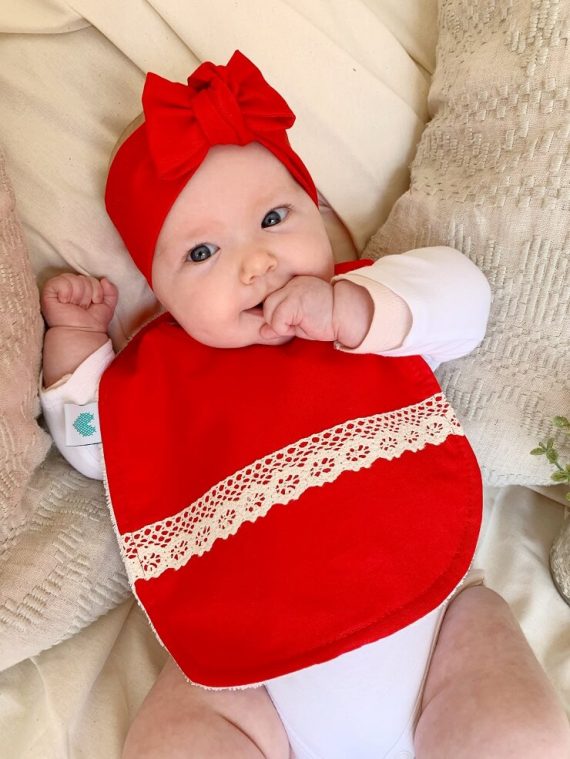baby wearing red boho christmas bib