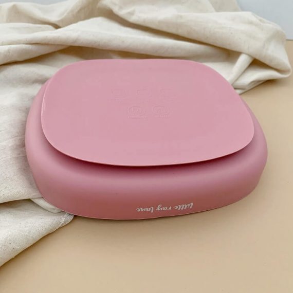 Rose coloured plate with suction cup made from silicone bottom view
