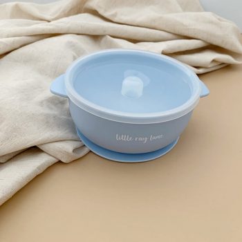 Bowl made from silicone with a suction cup in baby blue colour with lid