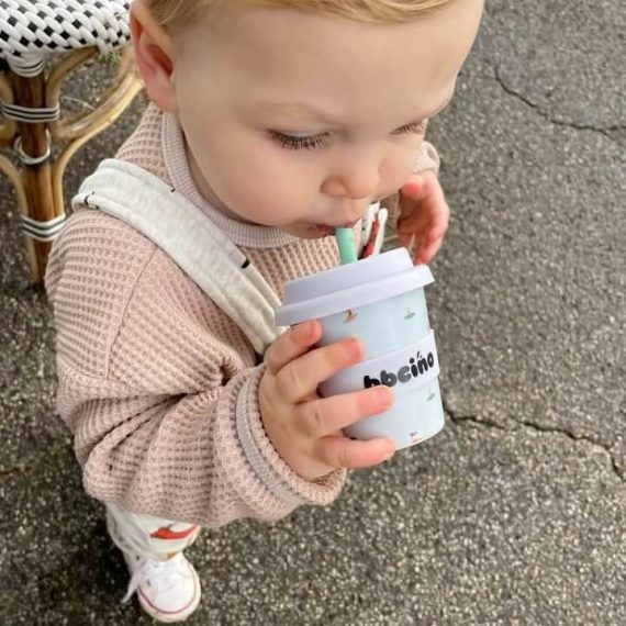baby drinking from a reusable cup