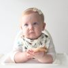 baby with rabbit print bib and oatmeal bow